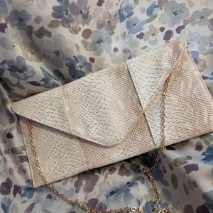 Faux python envelope purse.